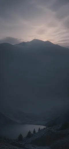 A cross above a mountain lake