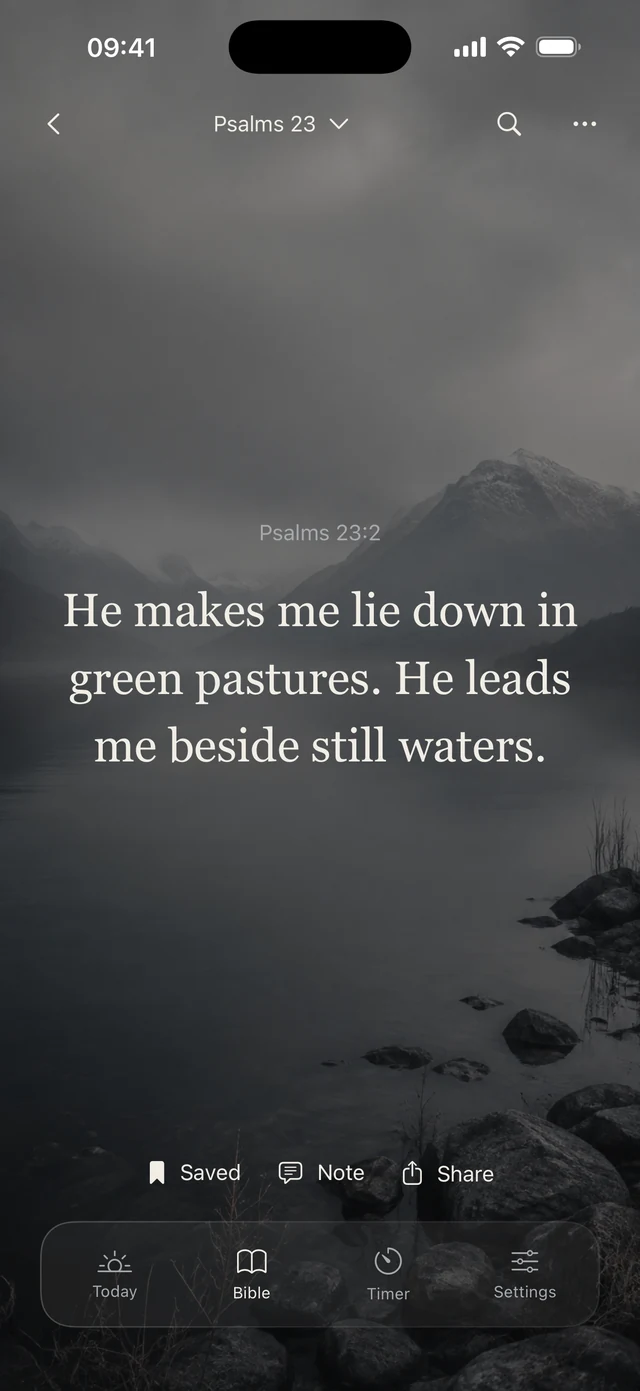 Psalm 23:2 in the Bible reader over a mountain lake